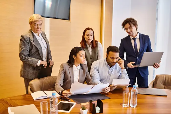 A diverse group of business professionals discussing ideas around a conference table. — Stock Photo