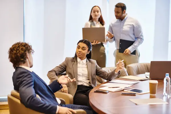 Multicultural group of professionals brainstorming around a conference table. — Stock Photo