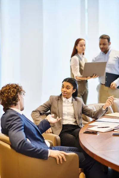 A diverse group of business professionals discussing at a conference table. — Stock Photo