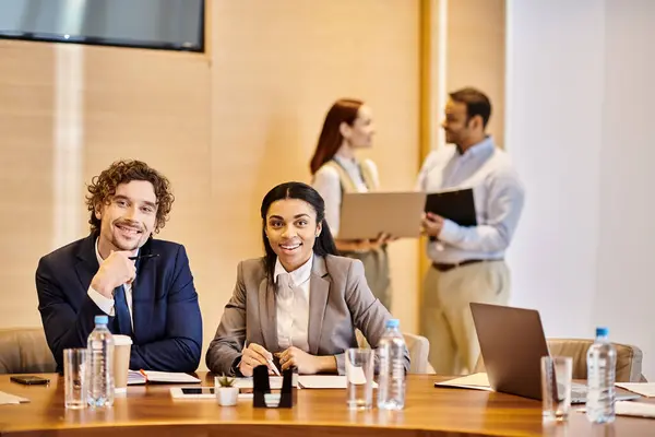 Multicultural business professionals sharing ideas around a conference table. — Stock Photo