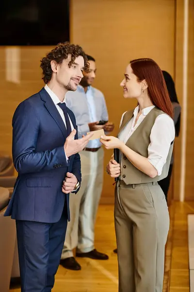 A stylish man and woman in business suits stand side by side. — Stock Photo