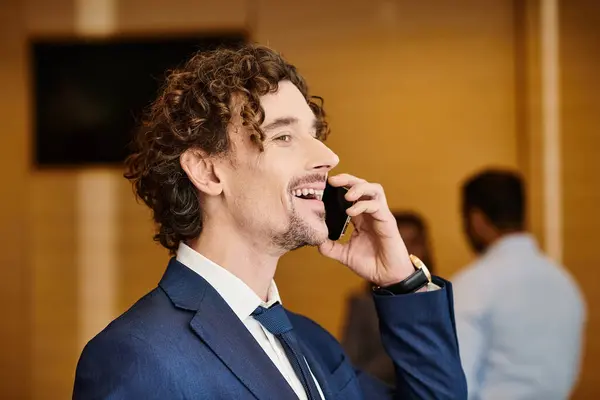 An interracial businessman in a suit talking on a cell phone. — Stock Photo