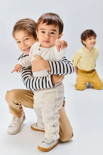 A young Asian children in a studio, forming a tight-knit family unit. — Stock Photo