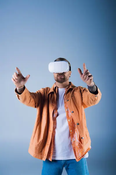 A man wearing a virtual reality headset in a studio setting, exploring the digital world of the Metaverse. — Stock Photo