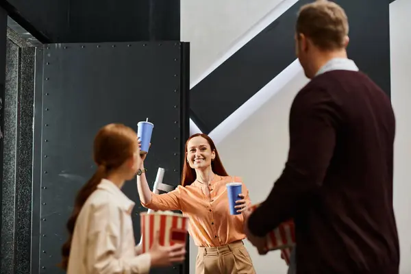A woman holds a cup as a man stands with daughter, capturing a moment of contemplation and togetherness in a happy family. — Stock Photo