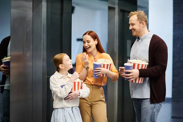 A man, woman, and child stand together in an elevator, smiling and enjoying their time together as a happy family. — Stock Photo