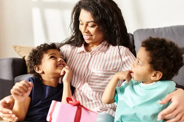 Merry attractive african american mother in homewear having great time with her little kids — Stock Photo