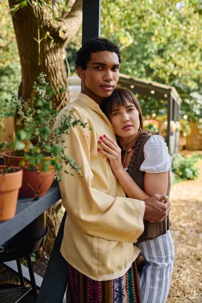 A man and woman of different races stand united beside each other, experiencing love and companionship in a beautiful natural setting. — Stock Photo