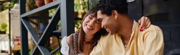 A man and a woman, an interracial couple, stand together by a camper van, symbolizing love and companionship on a romantic getaway in nature. — Stock Photo
