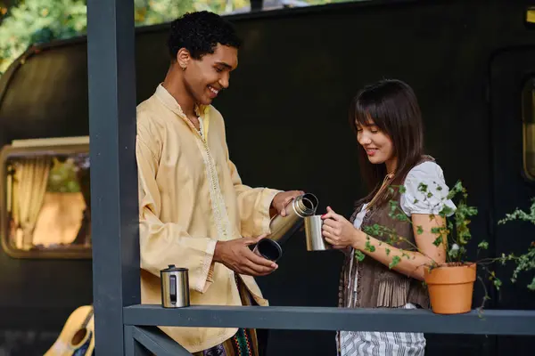 A man and a woman stand on a balcony, admiring the breathtaking view ahead of them on a romantic getaway. — Stock Photo