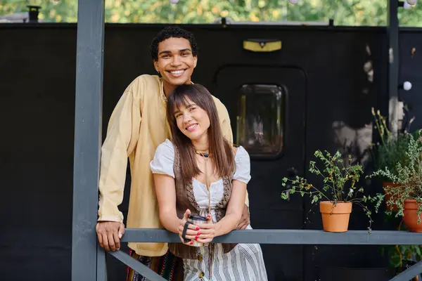 An interracial couple stands together in a serene natural setting, united in love and connection. — Stock Photo