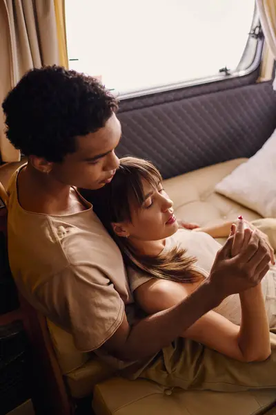 A man and a woman sit close together on a bed, sharing a moment of intimacy and connection in a cozy setting. — Stock Photo