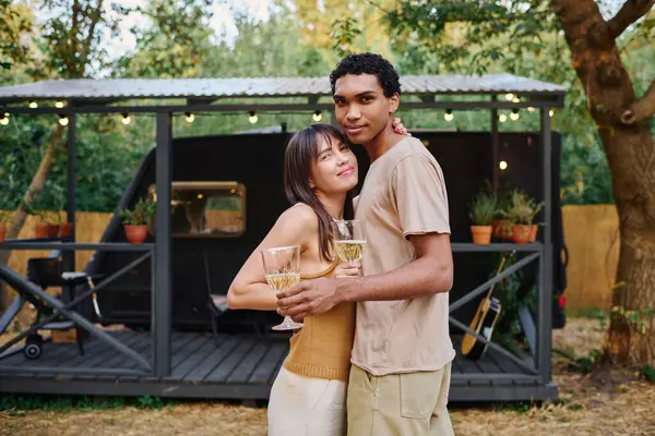 A man and a woman, an interracial couple, stand side by side, embarking on a romantic getaway in a camper van. — Stock Photo