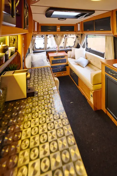 An eclectic mix of furniture fills a bus interior for romantic getaway. — Stock Photo