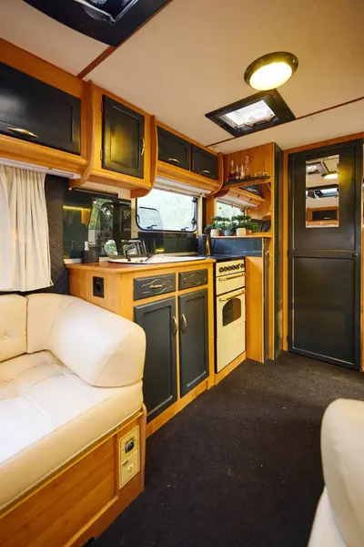 Camper van with cozy kitchen and living area for a romantic getaway adventure. — Stock Photo