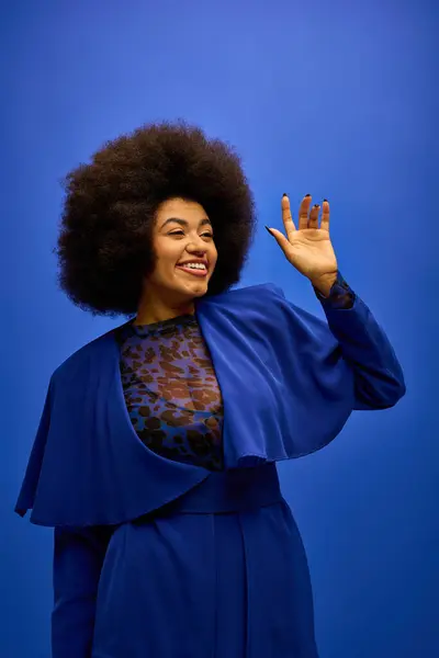 Stylish African American woman with curly hairdowaving. — Stock Photo