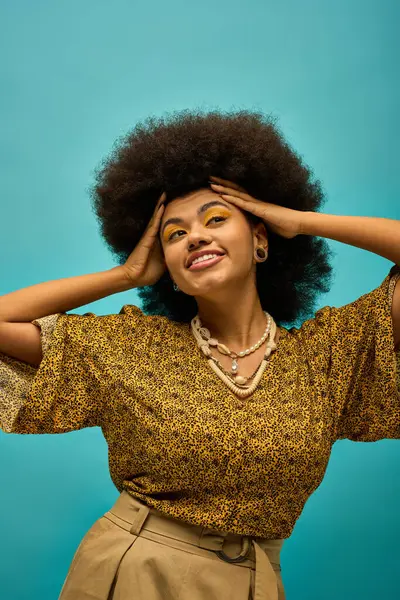 Stylish African American woman with a voluminous afro posing fashionably on a vibrant background. — Stock Photo