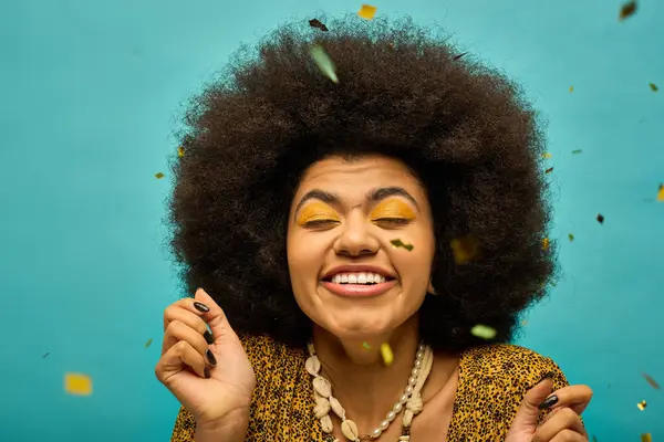 Stylish African American woman with curly hairdohair sketching with a pen in hand, surrounded by confetti. — Stock Photo