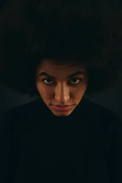 Trendy African American woman with large afro staring confidently at the camera. — Stock Photo