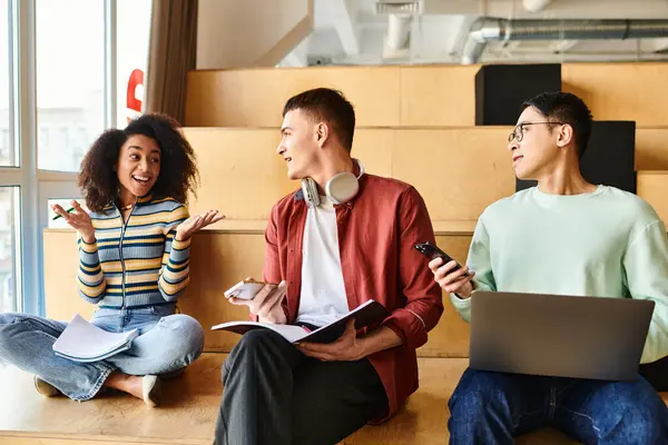 Multicultural group of students sit on floor, intensely focused on laptops for collaborative learning project — Stock Photo