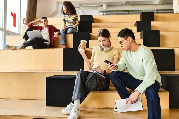 A multicultural couple sitting on steps, engaged in conversation and sharing a moment of connection and friendship — Stock Photo