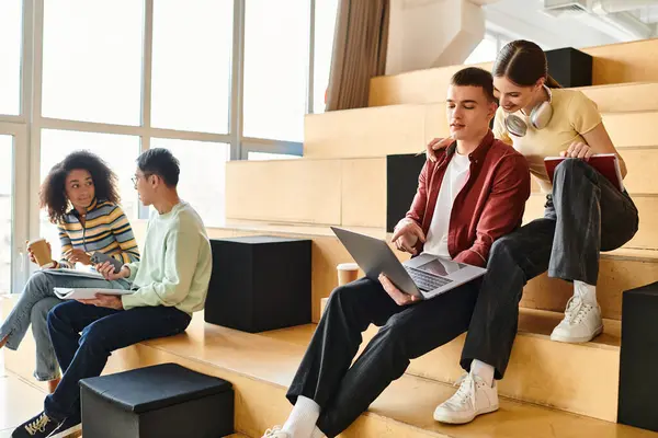 Multicultural group of students collaborating on steps with laptops for educational purposes — Stock Photo