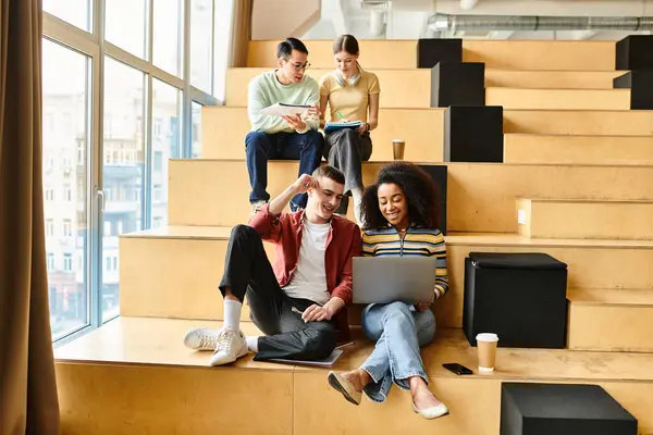 Multicultural students relax on steps of a modern building, chatting and laughing, embracing diversity — Stock Photo