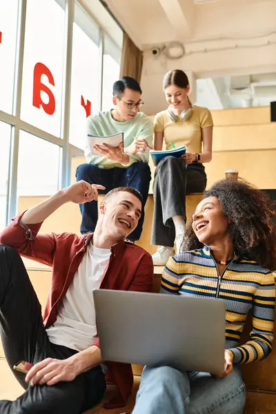 Multicultural group of students collaborating around a laptop for education or work purposes — Stock Photo