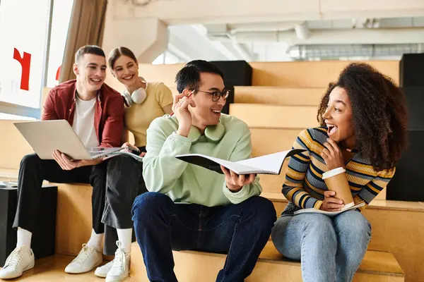 A multicultural group of students sit on urban stairs, taking a break from studies and enjoying each others company. — Stock Photo