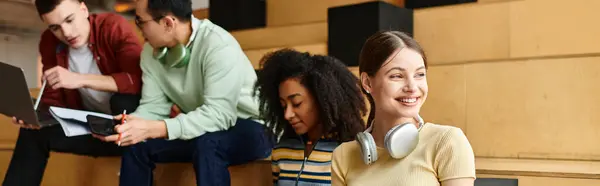 A diverse group of students from different backgrounds sitting together, engaged in conversation and sharing ideas indoors. — Stock Photo