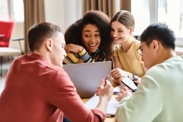 Multicultural group sits around laptop, engaged in discussion and learning — Stock Photo