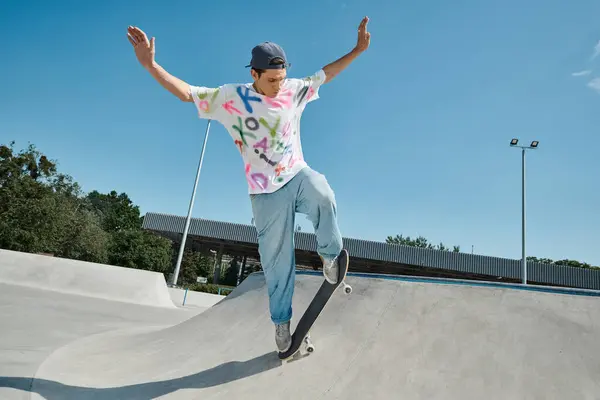 A young skater boy confidently rides his skateboard down the side of a ramp in a skate park on a sunny summer day. — Stock Photo