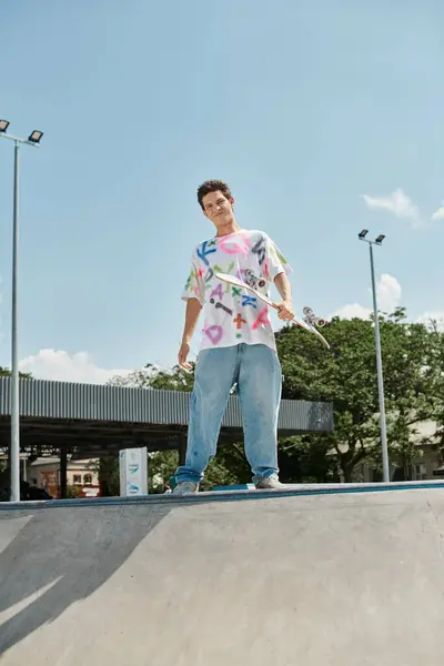 Young skater boy confidently rides skateboard up the ramp at a bustling outdoor skate park on a sunny summer day. — Stock Photo