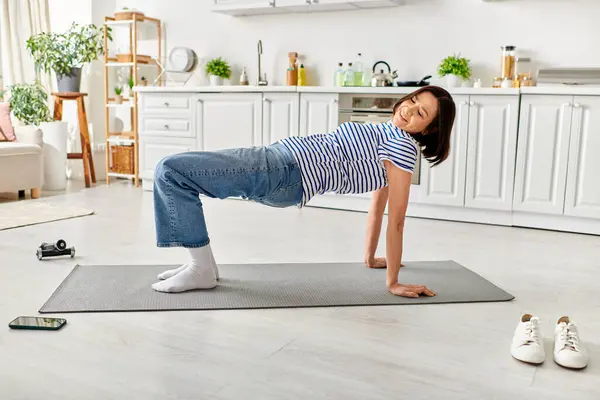Young girl gracefully practices yoga on mat. — Stock Photo