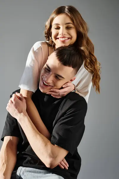 A man showcasing his strength by carrying a woman on his back, showcasing love and connection between the couple. — Stock Photo