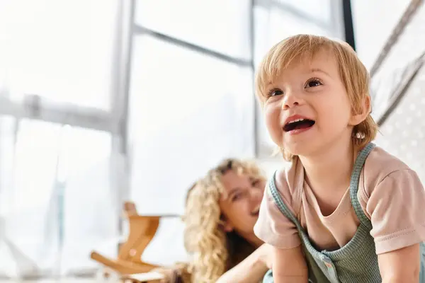 A little girl with a surprised expression smiling in front of a window at home. — Stock Photo