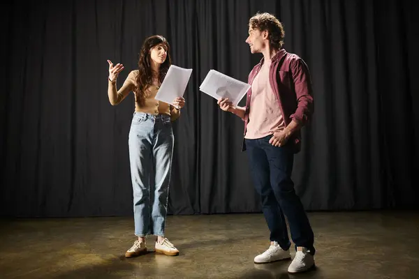 Ein Mann und eine Frau begutachten gemeinsam Papiere bei Theaterproben. — Stockfoto