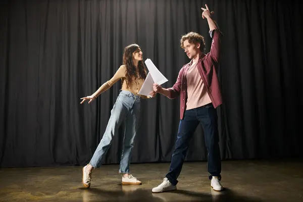 A handsome man and a beautiful woman rehearsing on stage. — Stock Photo
