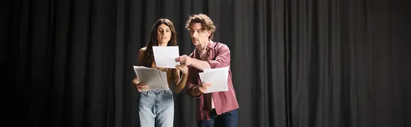 A man and a woman captivate the stage during theater rehearsals. — Stock Photo