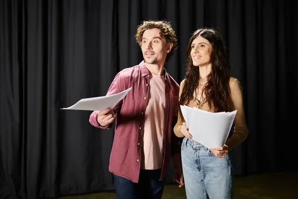 Un hombre y una mujer juntos, ensayando para una producción de teatro. - foto de stock