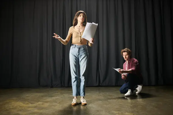 A woman and man stand together on a stage during theater rehearsals. — Stock Photo