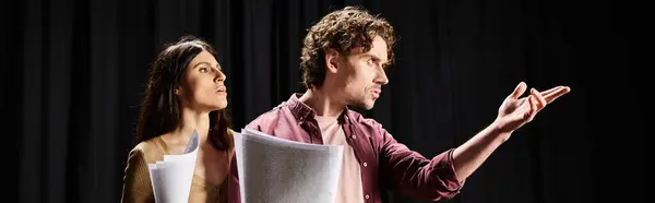 A man and woman stand poised during theater rehearsals. — Stock Photo