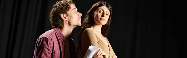 A handsome man and a beautiful woman stand next to each other during theater rehearsals. — Stock Photo