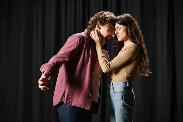 A handsome man and a beautiful woman rehearsing on a theater stage. — Stock Photo