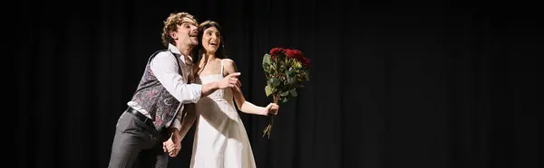 Handsome man presenting bouquet to beautiful woman during theater rehearsal. — Stock Photo