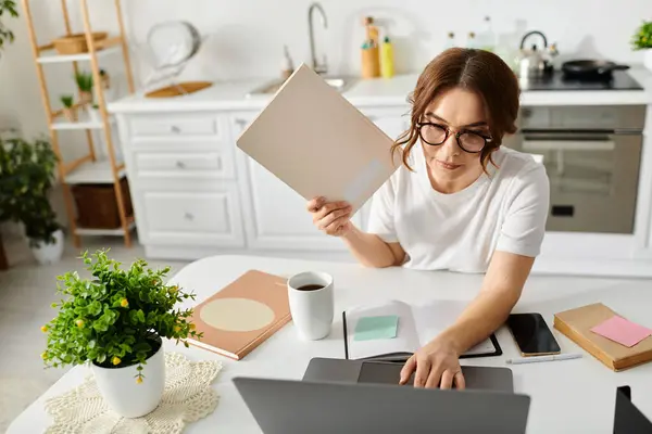 Mulher de meia-idade trabalhando no laptop em casa . — Fotografia de Stock