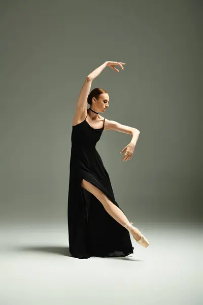 Talented young ballerina exudes elegance in a black dress, dancing gracefully. — Stock Photo