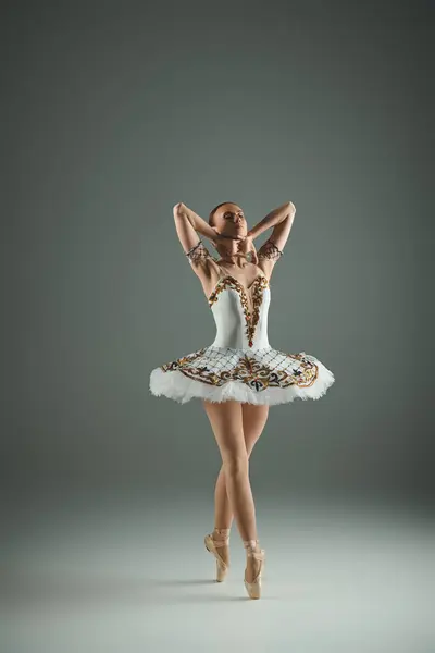 Young, beautiful ballerina in white tutu striking a pose. — Stock Photo