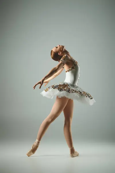 Young ballerina dances gracefully in white tutu and leotard. — Stock Photo
