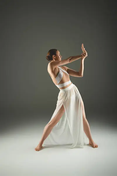 Graceful ballerina in white dress strikes a pose — Stock Photo